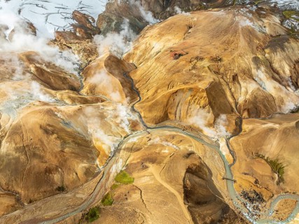 Steaming hot springs and colourful rhyolite mountains, aerial view, Hveradalir geothermal area,