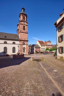 Old market square or Schnatterloch with St James' parish church and historic houses under a blue,
