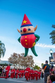 Elf helium balloon and its handlers in the Macy's Holiday Parade at Universal Studios, Orlando,