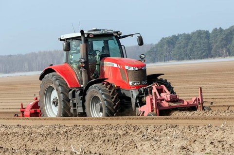 Preparations for the asparagus season. The soil is loosened with a tiller at the front of the
