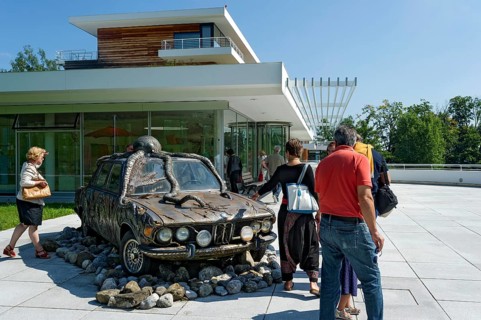 Visitors look at former BMW 250cs by Lothar-Günther Buchheim, car under water with octopus,