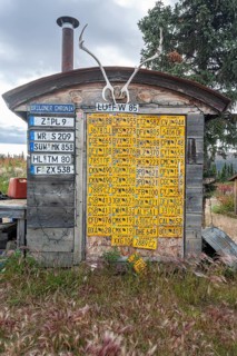 Funny wooden hut with car licence plates, collection, Top of the World Highway, Alaska, USA, North