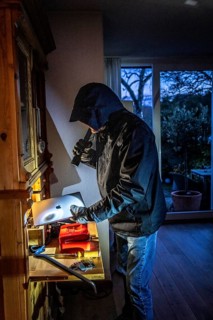 Symbolic image of a burglary, perpetrator has broken into a flat from the garden side and is