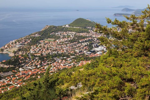 High angle view of tan and white trim houses and villas with traditional terracotta clay tile