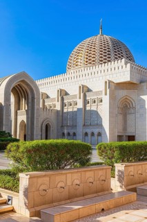 Great hall with dome of the Sultan Qaboos Mosque, in front of it water points for foot washing,