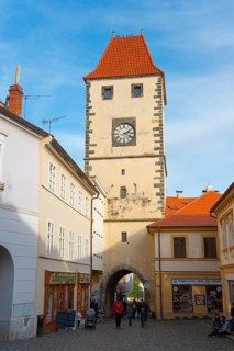Historic tower with clock in a Bohemian old town, architectural landmark, Prague Tor, Melnik,