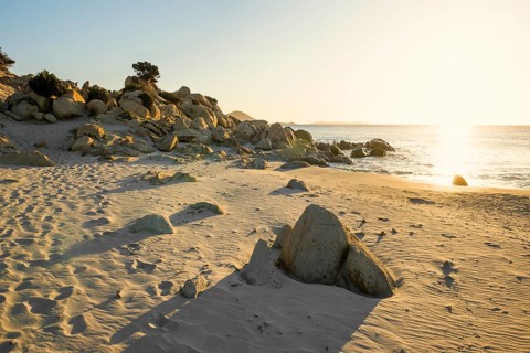 Lonely beach and rocks, sunrise, Spiaggia di Porto Giunco, Villasimius, south coast, Sardinia,