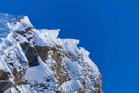 Snow-covered mountain peak with snow cornices under a clear blue sky, Gemmi Pass, Plattenhörner,