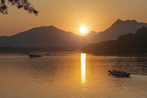 Sunset on the Mekong with excursion boats, near Luang Prabang, Laos, Asia