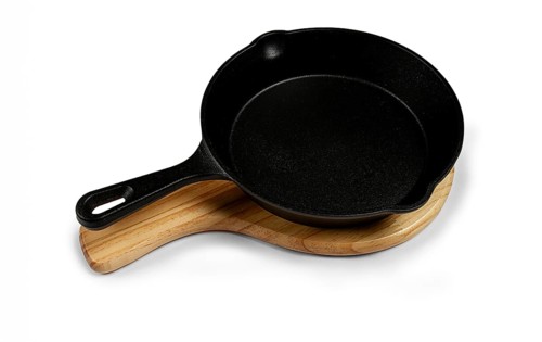 Portioned cast iron frying pan, on a wooden stand, new, on a white background, isolate