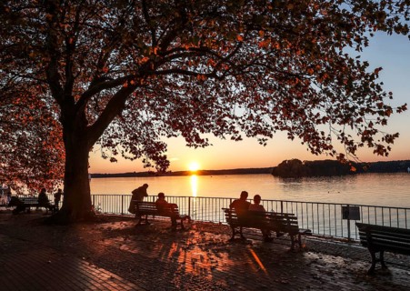 Visitors to the promenade on Lake Tegel enjoying the sunset, Berlin, 25 October 2024, Berlin,