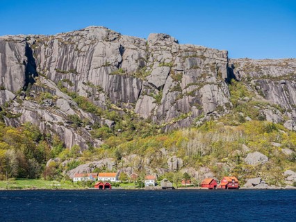 Steep granite mountains at the sea near Ana Sira, village Stornes, typcial coastal village, at