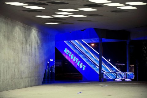 Illuminated escalator to the Autostadt under the phæno building at night, Wolfsburg, Lower Saxony,