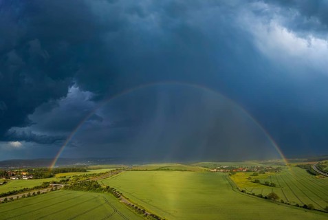 Thunderstorm cell with rainbow over fields near Krebs in the Osterzgebirge, Krebs, Saxony, Germany,