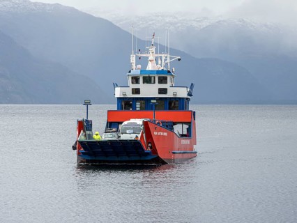 Ferry from Rio Bravo approaching Caleta Yungay on a rainy day, Patagonia, Chile, South America