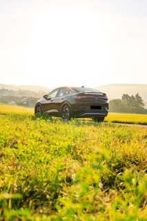 SUV driving through a green rural environment with a sunny background, VW ID5 electric car, Calw,