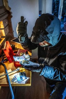 Symbolic image of a burglary, perpetrator has broken into a flat from the garden side and is