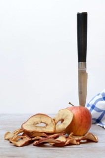 Apple with knife and apple rings, dried fruit