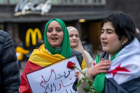 Syrian woman celebrate the end of the Assad regime after the change of power in Syria at a rally on