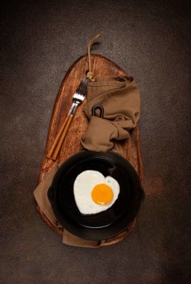 Fried egg in a cast-iron pan, breakfast, fried eggs in the shape of a heart, top view, no people,