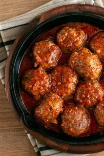 Minced meat meatballs, in tomato sauce, in a cast-iron pan, homemade, no people