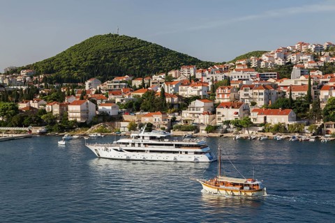 Suzana Zantium private yacht and sightseeing boat plus tan and white trim houses and villas with