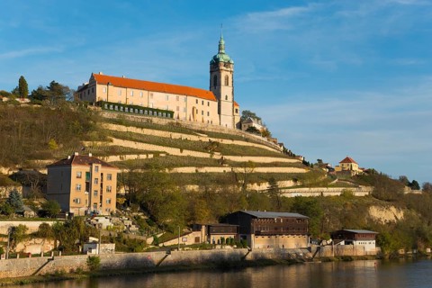 Historic church on a terraced hill with clear blue sky and surrounding nature, Melnik Castle,