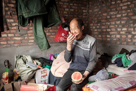 Worker Yang Zhao Bin at his sleeping place, the workers live in the respective buildings where the