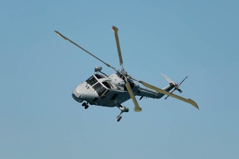 Military helicopter in blue sky