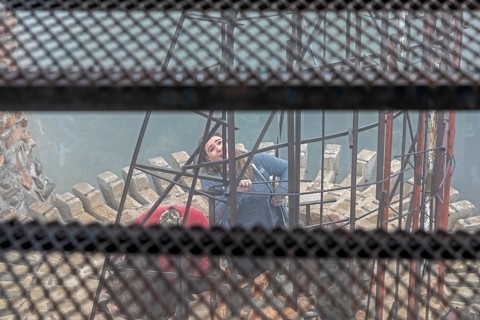 Rye, Colorado, Visitors explore a tower on Bishop Castle on a foggy morning. The Castle is an