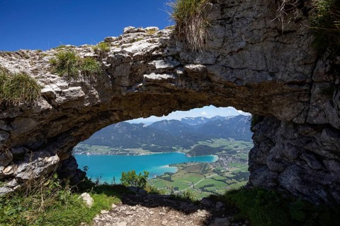 Rock window, view through the Ofenloch on the Bleckwand towards Strobl with Wolfgangsee,