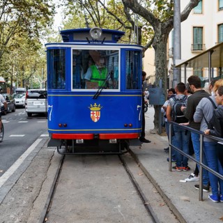 Nostalgic blue tram, tourist group waiting at the stop, Tramvia Blau, Art Nouveau, Barcelona,