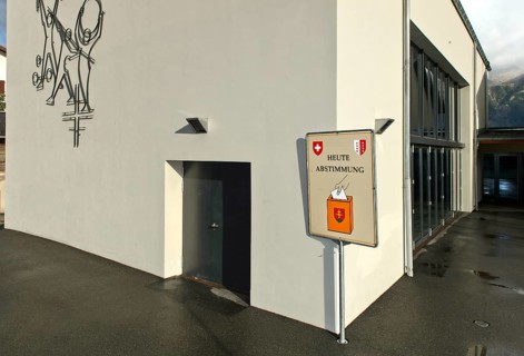 Sign inviting people to participate in referendums in front of the polling station, Unterbäch,