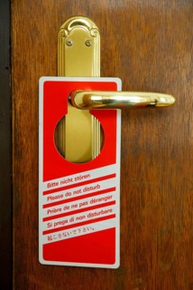 Sign on door handle of hotel room 'Do not disturb', Please do not disturb, door handle