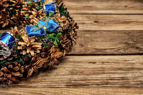 Christmas wreath on old wooden background close up