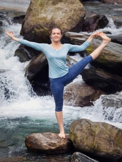 Yoga outdoors, woman doing Ashtanga Vinyasa Yoga balance asana Utthita Hasta Padangushthasana,