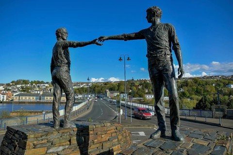 Bronze sculpture Hands Across the Divide by Maurice Harron at the Craigavon Bridge over the River