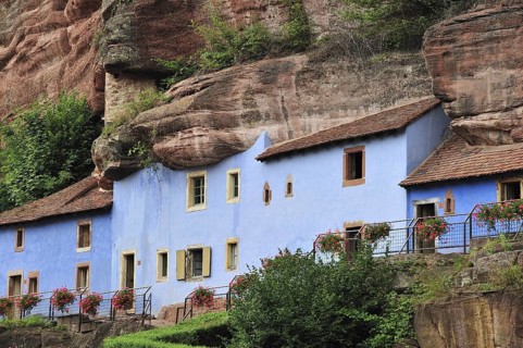 The blue troglodyte houses in rock face at Graufthal, Vosges, Alsace, France, Europe