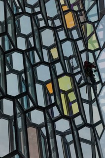 Window cleaners cleaning the glass facade of the Harpa Concert Hall and Congress Centre, interior