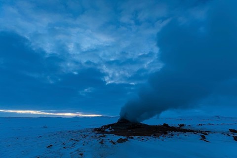 Mud pot with steam source at dawn, Hverir solfatar field, fumaroles, snow-covered geothermal area,