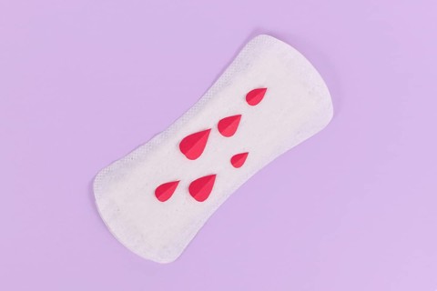 Female period concept with panty liner with symbolic paper blood