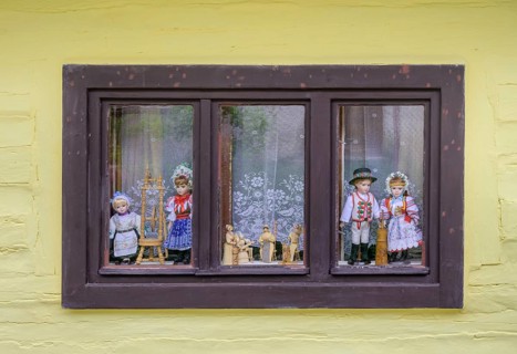 Window with traditional traditional costume dolls, Vlkolinec village, Unesco World Heritage Site,