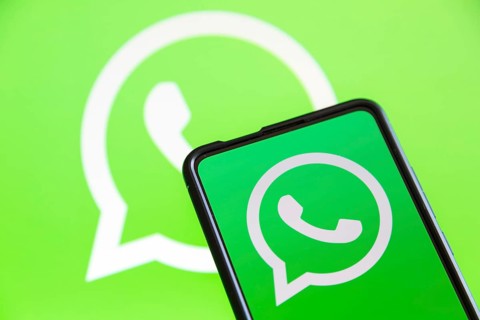 WhatsApp logo messenger app on a mobile phone and computer screen