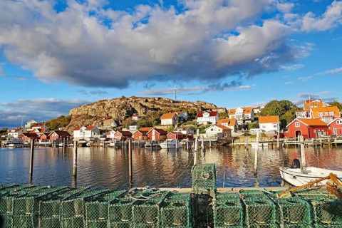 Lobster cages, harbour and small wooden houses in the autumn evening light, Fjällbacka, Bohuslän,