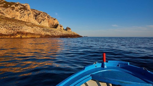 Evening light, boat tour, boat bow, view from the sea, bizarre rock formations, rugged mountains,
