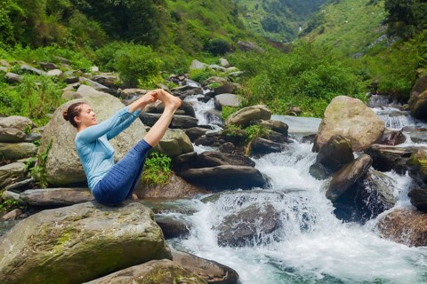 Yoga exercise outdoors, panorama of woman doing Ashtanga Vinyasa Yoga balance asana Ubhaya