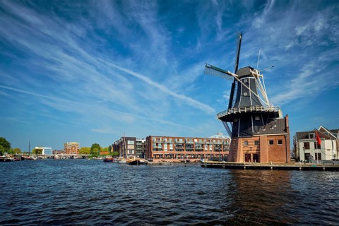 View of Harlem landmark windmill De Adriaan on Spaarne river. Harlem, Netherlands