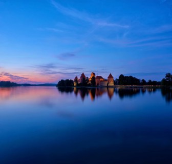 Evening view of Trakai Island Castle in lake Galve illuminated in the night, Lithuania. Square