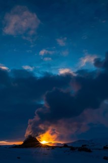 Mud pot with steam source at sunrise, Hverir solfataras field, fumaroles, snow-covered geothermal