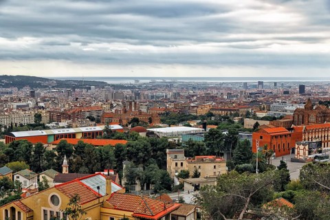 View of the sea of houses up to the coast, cloudy sky in autumn, haze, Tibidabo, Barcelona, Spain,